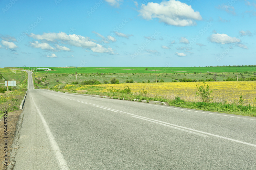 Country road over blue sky background