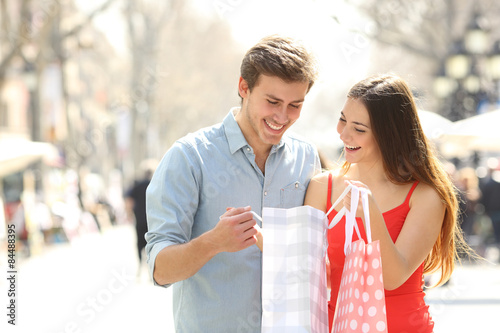 Couple shopping and holding bags in the street photo