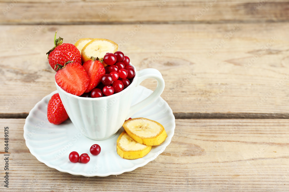 Cup of dessert with fresh fruits on wooden table, closeup Cup of dessert with fresh fruits on wooden table, closeup
