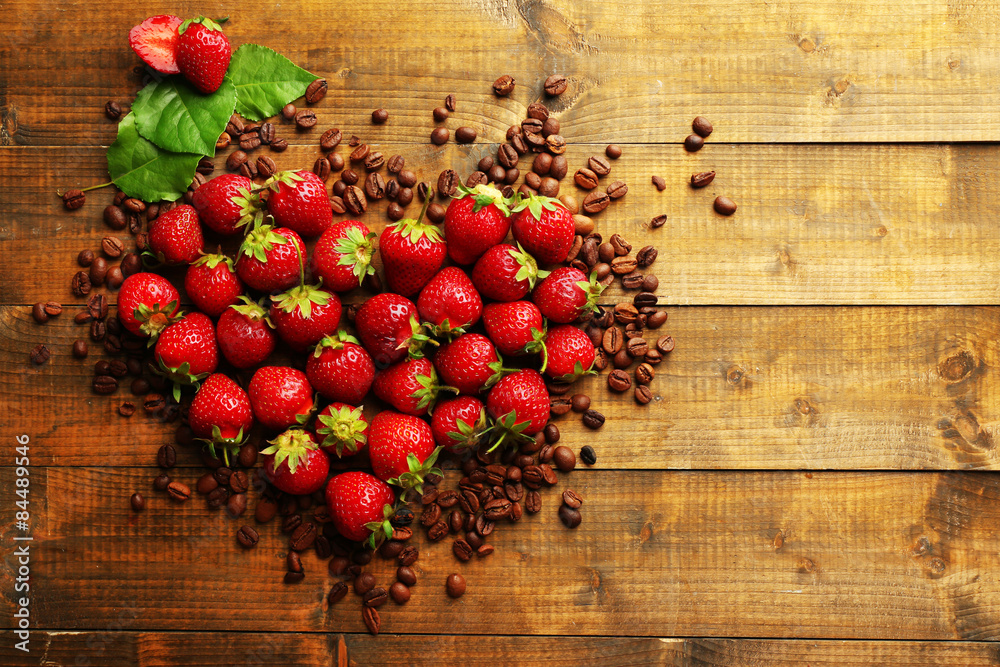 Fresh strawberry with coffee beans in shape of heart on wooden background Fresh strawberry with coffee beans in shape of heart on wooden background