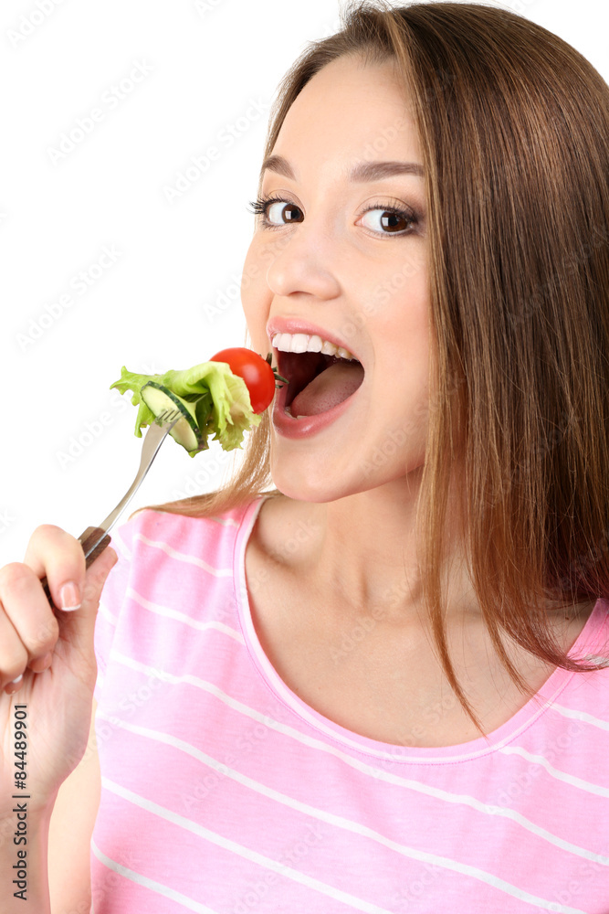 Healthy young woman with vegetables on fork isolated on white Healthy young woman with vegetables on fork isolated on white