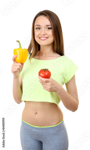 Healthy young woman with pepper and tomato isolated on white