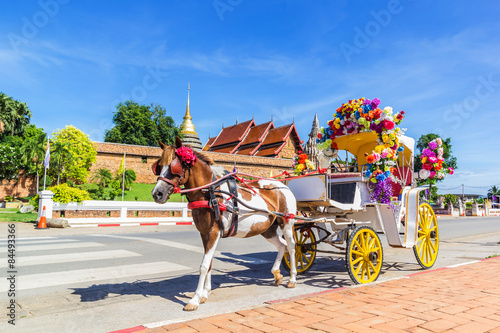 Horse carriage front of Wat Phrathat Lampang temple photo