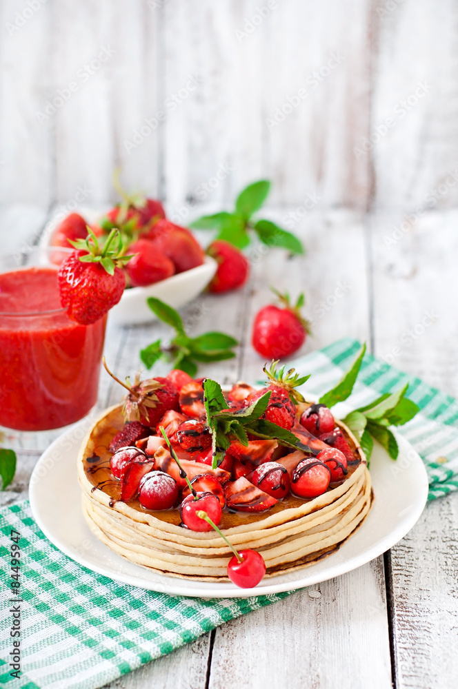Pancakes with berries and strawberry smoothie in a rustic style Pancakes with berries and strawberry smoothie in a rustic style
