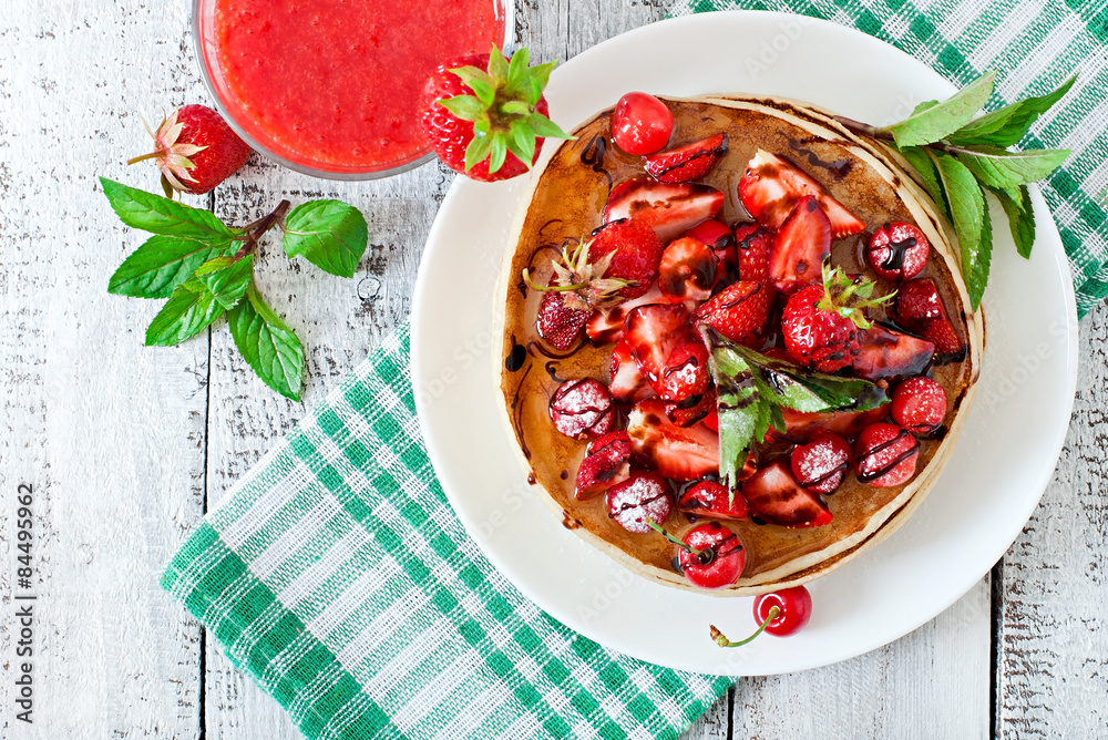 Pancakes with berries and strawberry smoothie in a rustic style Pancakes with berries and strawberry smoothie in a rustic style