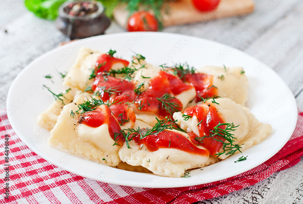 Delicious ravioli with tomato sauce and dill Delicious ravioli with tomato sauce and dill