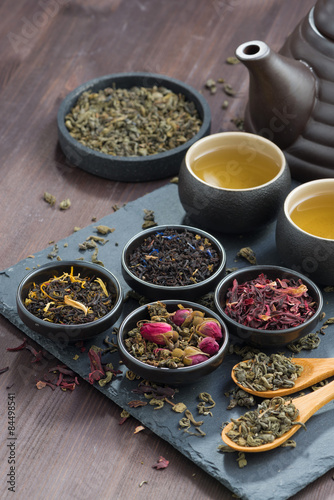 assortment of fragrant dried teas and green tea, vertical