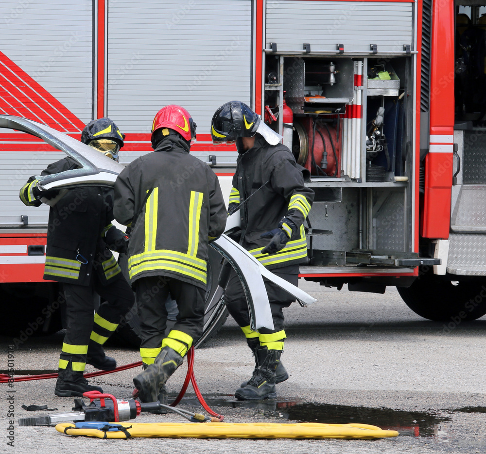 firefighters during a road accident with car parts firefighters during a road accident with car parts