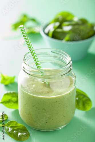 healthy green smoothie with spinach mango banana in glass jars