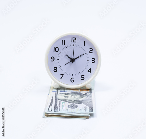 Clock and dollar bill for money and time concept