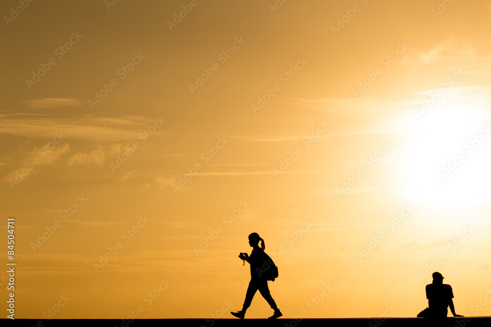 Fototapeta premium Silhouette people walking at sunset