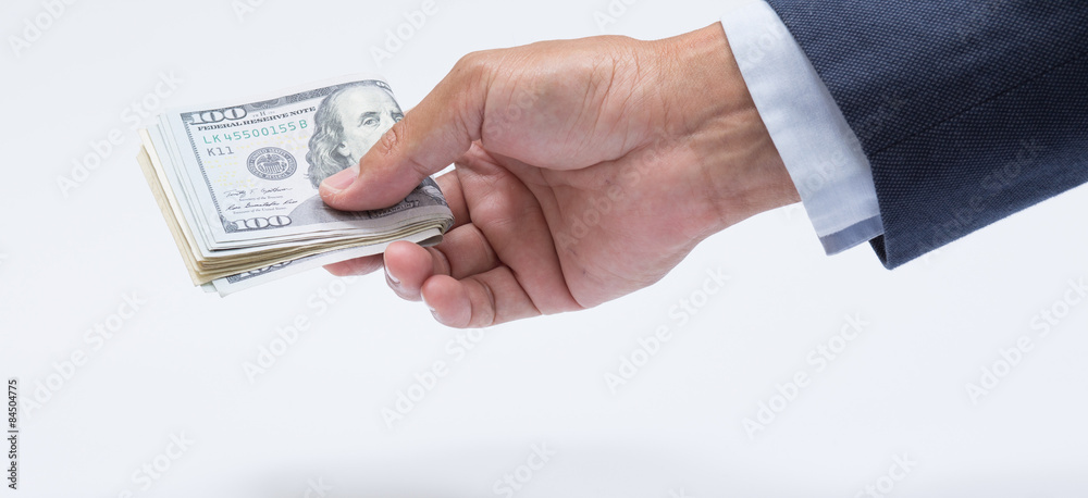 Businessman hand holding us dollar banknote Businessman hand holding us dollar banknote
