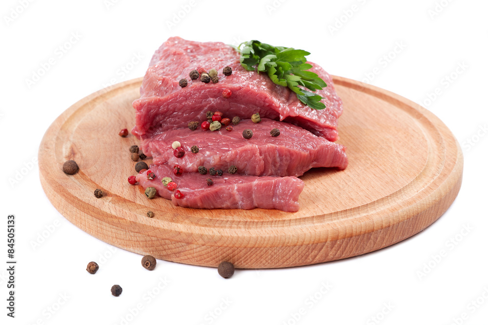 Meat on a cutting board isolated on white background.