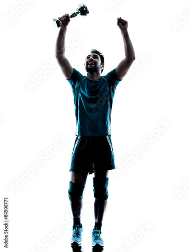 man  winning holding trophy cup silhouette