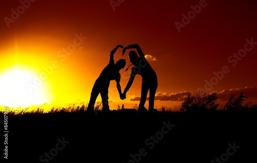 Two silhouette at sunset, a boy and a girl, a declaration of love