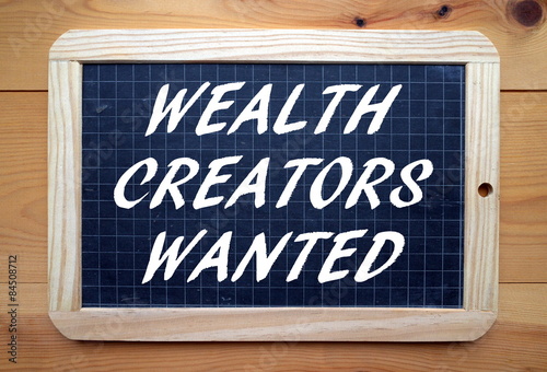 The phrase Wealth Creators Wanted on a blackboard