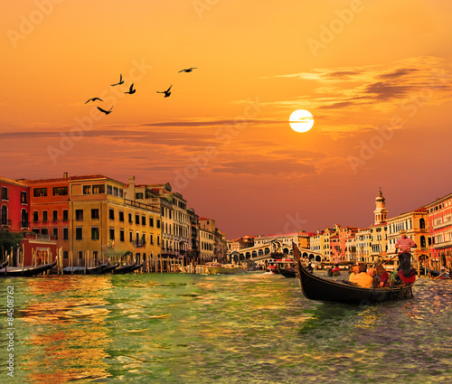 Venice Grand canal, gondolas and Rialto Bridge at sunset, Italy