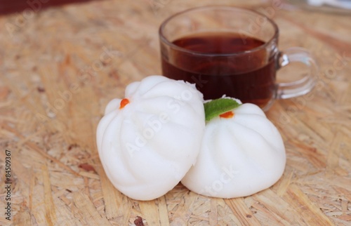 steamed pork buns, chinese dim sum and hot tea