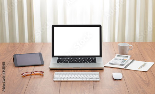 Blank screen laptop computer on wooden table