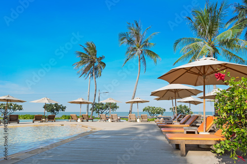 Perfect beach swimming pool with tropical resort relax.