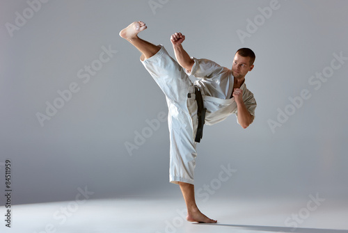 Man in white kimono training karate