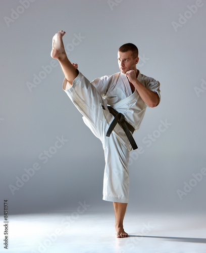 Man in white kimono training karate