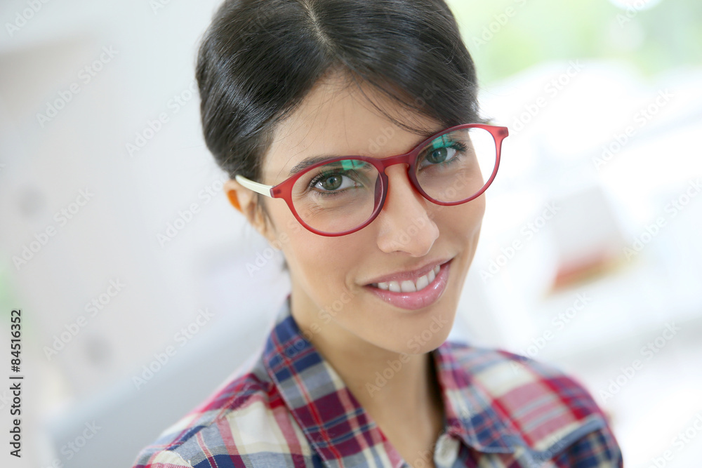 Portrait of brunette girl with red eyeglasses on, isolated Portrait of brunette girl with red eyeglasses on, isolated