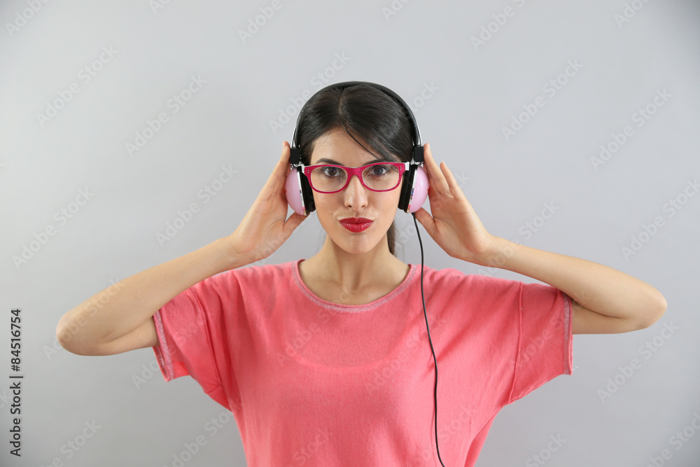 Clsoeup of brunette girl with eyeglasses using headphones Clsoeup of brunette girl with eyeglasses using headphones