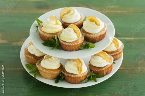 Homemade cupcakes on green wooden background