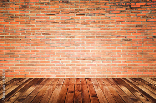 Old interior room with brick wall and wood floor