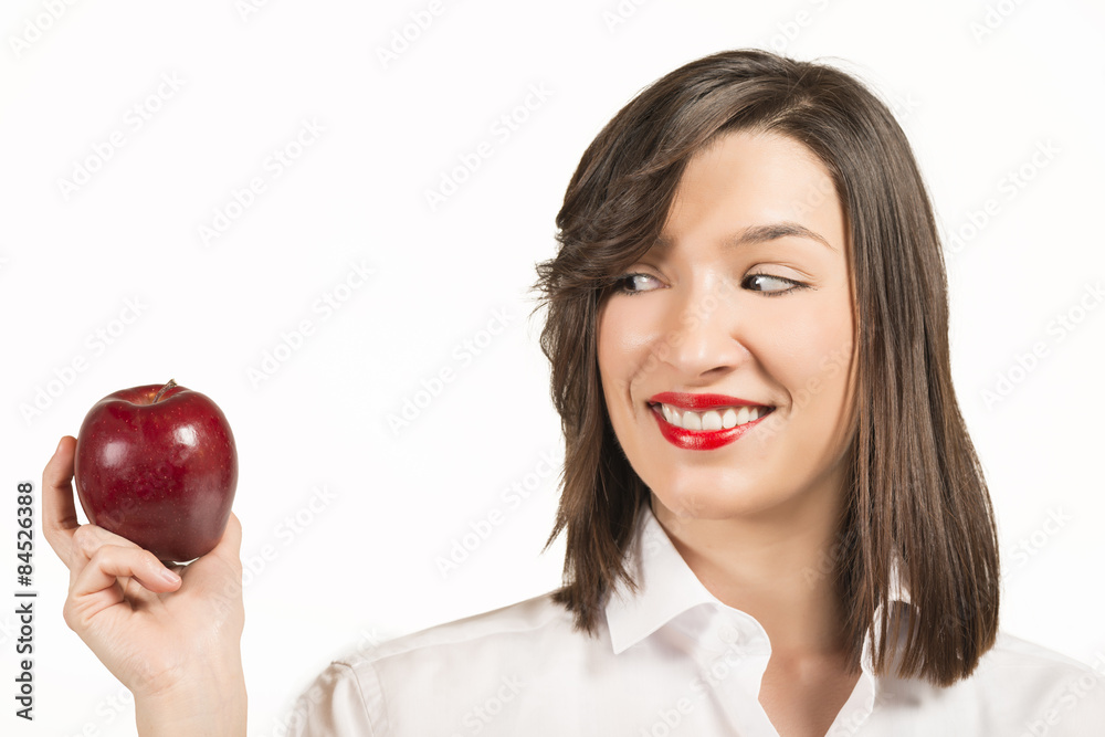Beautiful young woman eating an red apple, studio shot on white Beautiful young woman eating an red apple, studio shot on white