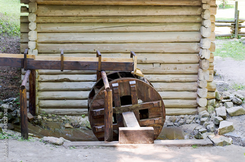 Wooden wheel of an ancient water mill in open-air museum,Ukraine photo