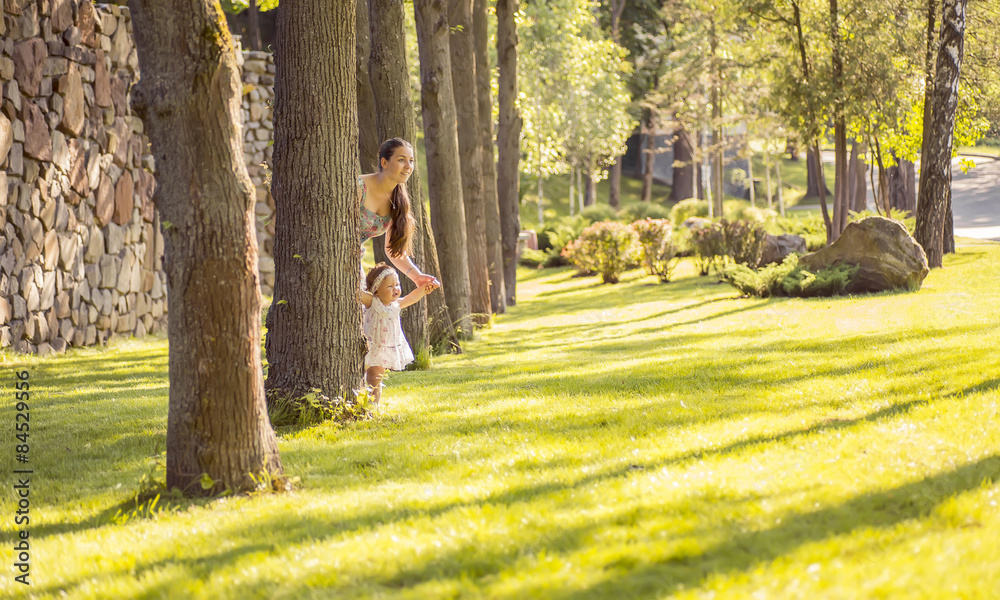 Fototapeta premium mother and daughter walking in the park, happy summer