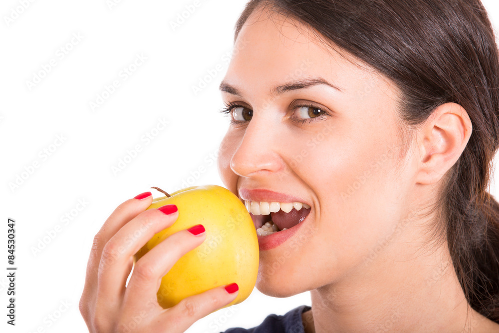 young woman eating apple, looking at camera, white background young woman eating apple, looking at camera, white background