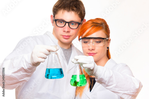 Two chemists holding a test tube in a lab