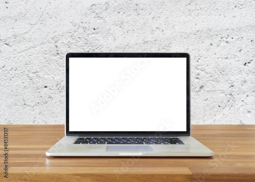 Laptop on table, on  white cement wall background