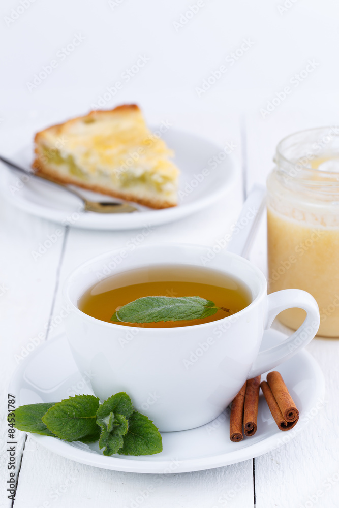 Mint tea with cinnamon on wooden table. Mint tea with cinnamon on wooden table.