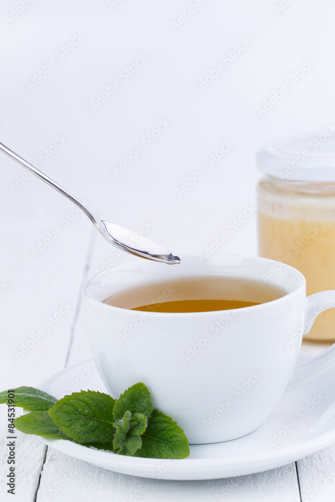 Mint tea with honey on wooden table. Mint tea with honey on wooden table.