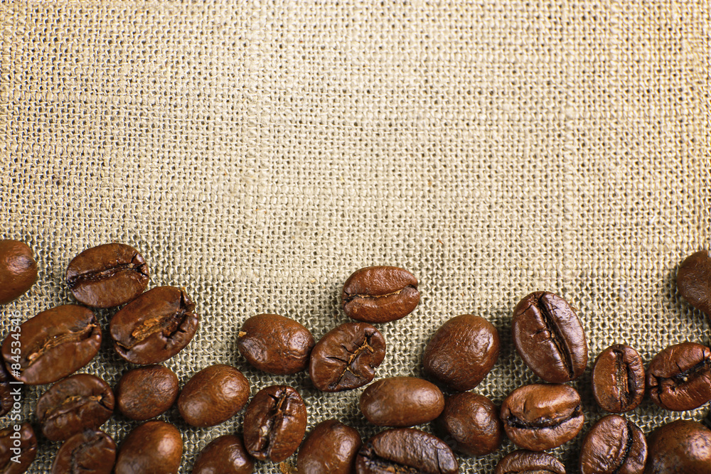 Frame of coffee beans on color sackcloth background Frame of coffee beans on color sackcloth background