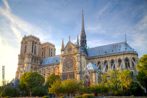 Gorgeous sunset over Notre Dame cathedral with puffy clouds, Par