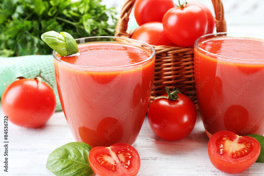 Glasses of fresh tomato juice on wooden table, closeup Glasses of fresh tomato juice on wooden table, closeup