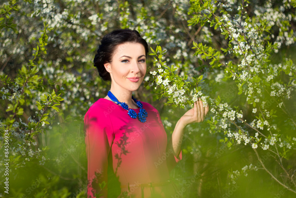 portrait of young beautiful woman in garden with blooming trees portrait of young beautiful woman in garden with blooming trees