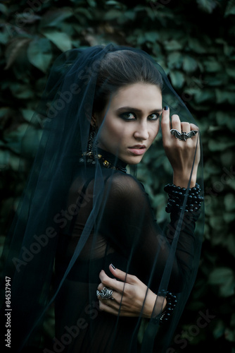 Fashiom model dressed in gothic style. Vamp. photo