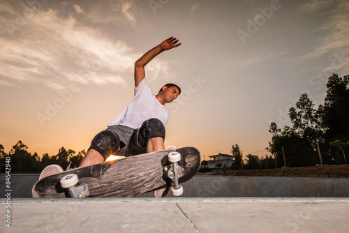 Skateboarder in a concrete pool photo