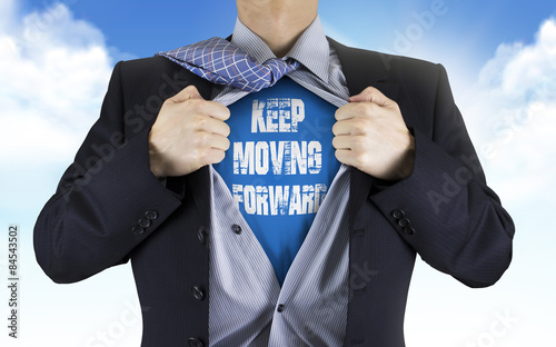 businessman showing Keep moving forward words underneath his shi