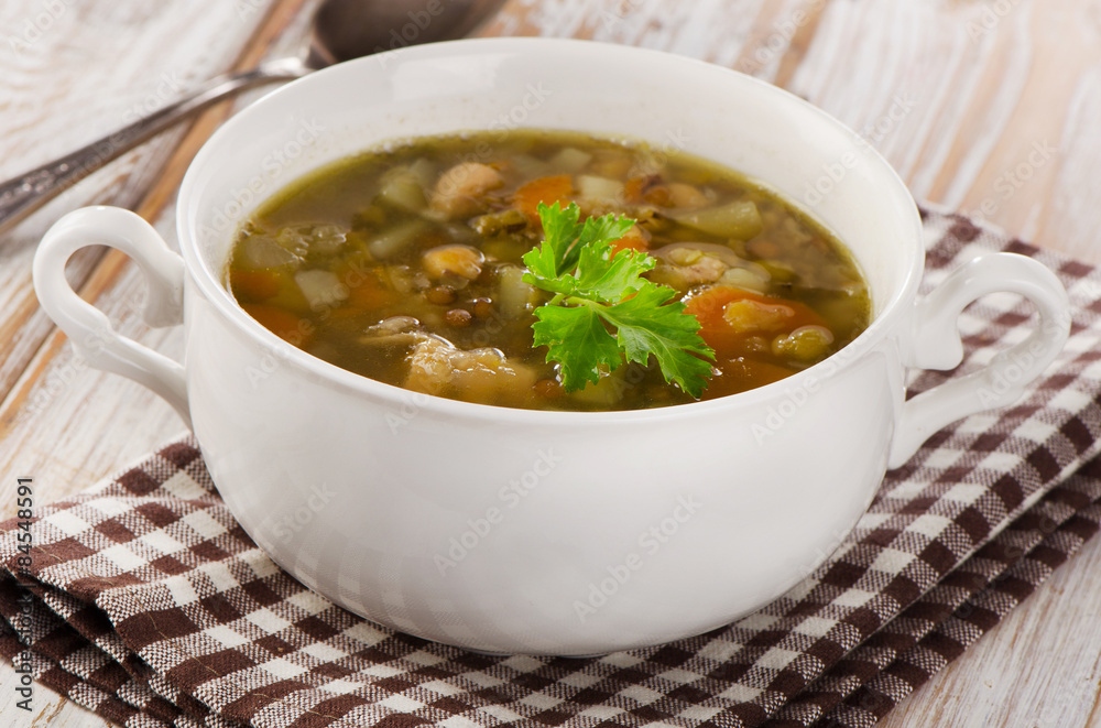 Bowl of Soup with Lentils, Beans, Chicken and Vegetables.