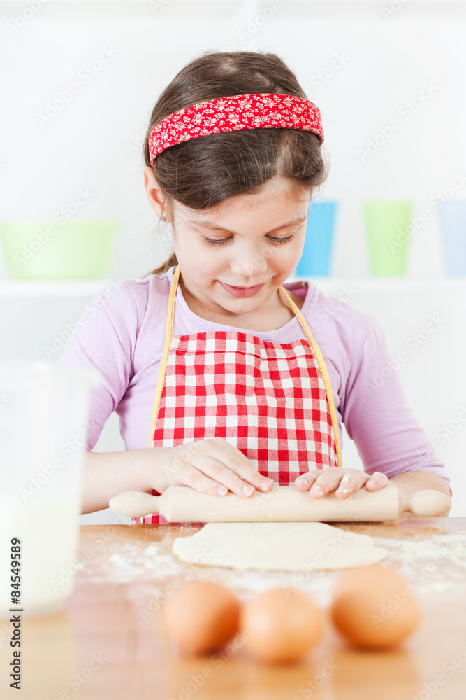 Little girl making the dough Little girl making the dough