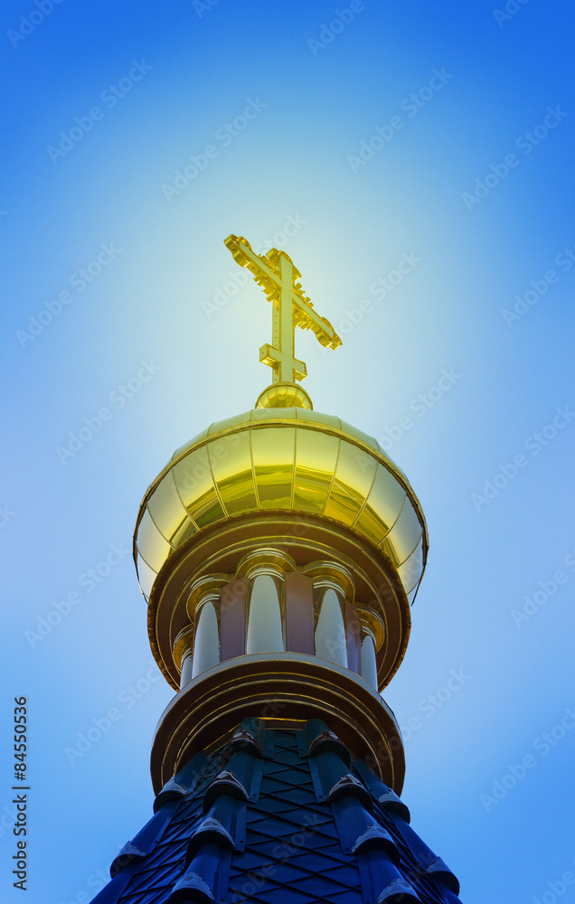 A Golden dome with a cross of the Church