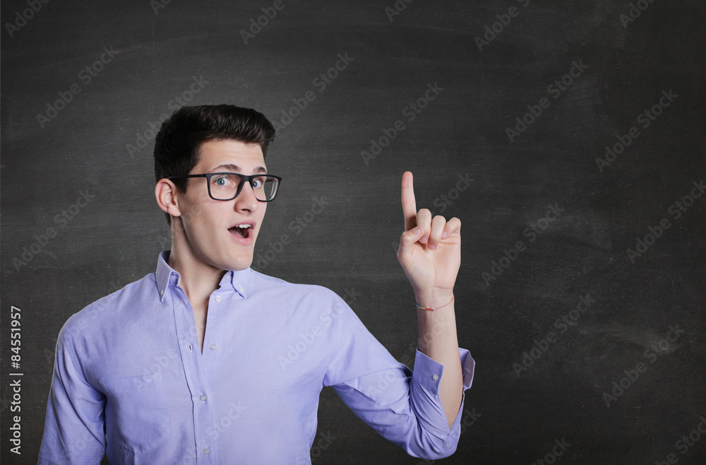 Happy smiling young man presenting and showing your text Happy smiling young man presenting and showing your text