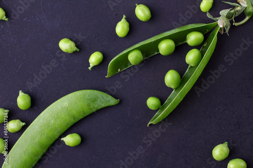 Fresh green peas on a black background photo